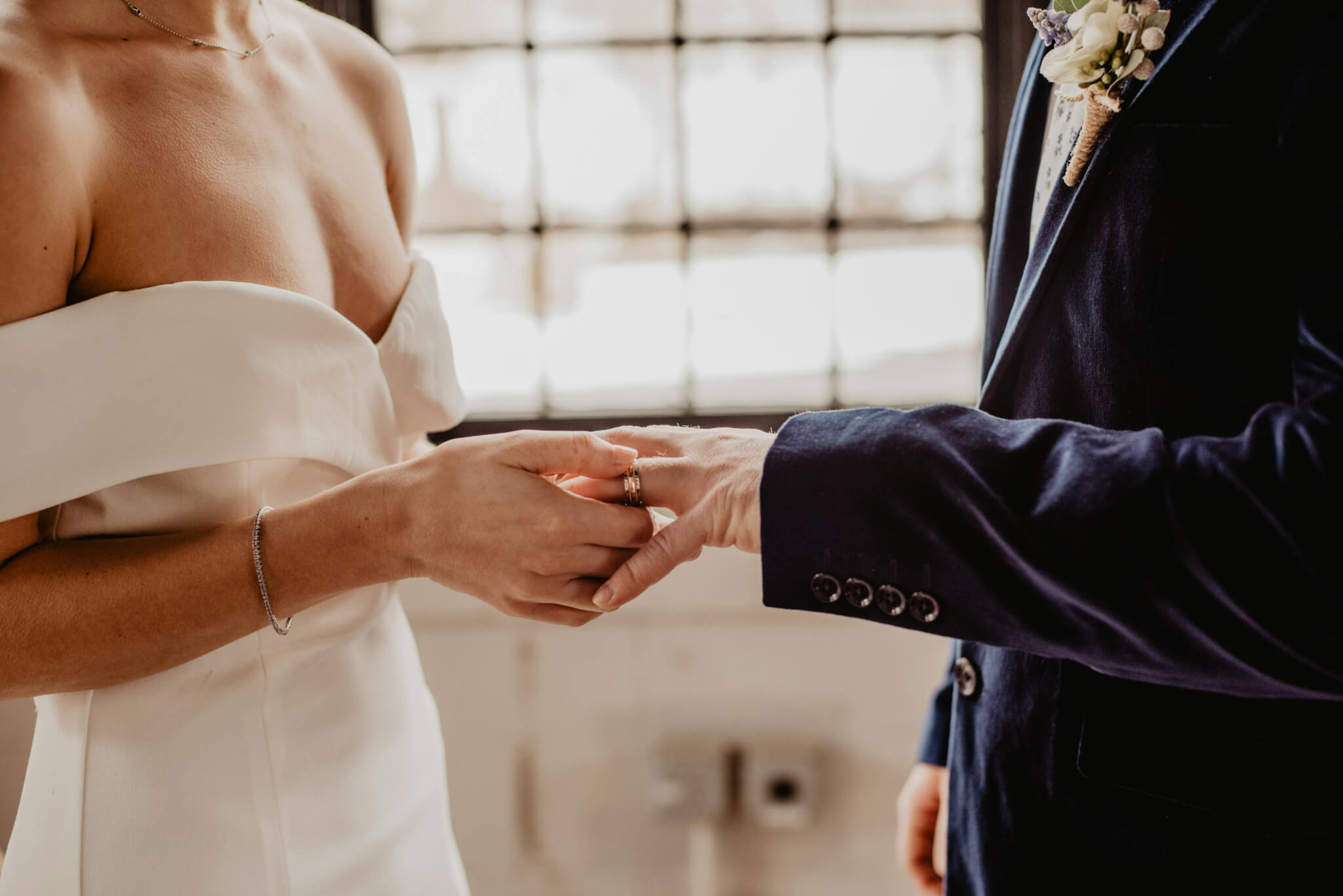 Spa 8 Newlywed couple exchanging wedding rings, symbolizing their union.