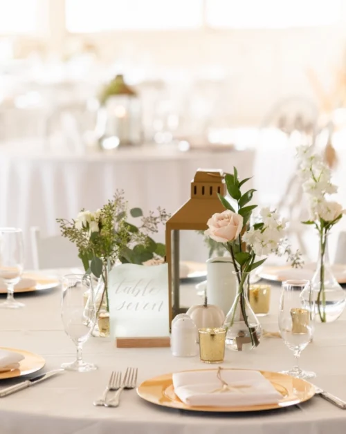 Weddings 16 Elegant table number 7, adorned with a charming candle centerpiece and delicate floral motifs.