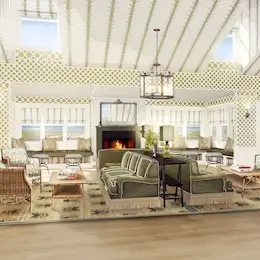 Homepage 25 Cozy lounge with a fireplace, large sofas, and rugs, perfect for relaxing.